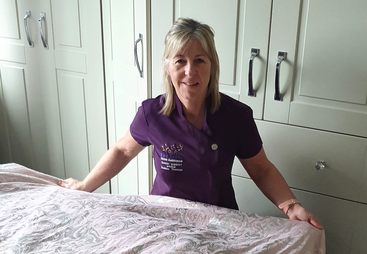 Debbie making the beds with fresh clean bedding.